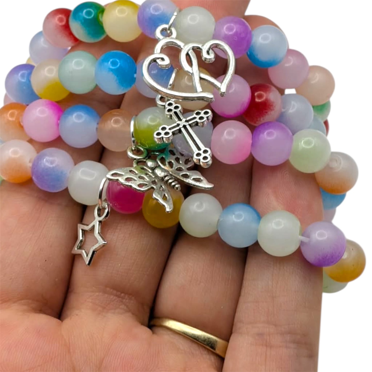 Beaded bracelets featuring colorful glass beads and charming silver accents in a hand holding multiple bracelets.