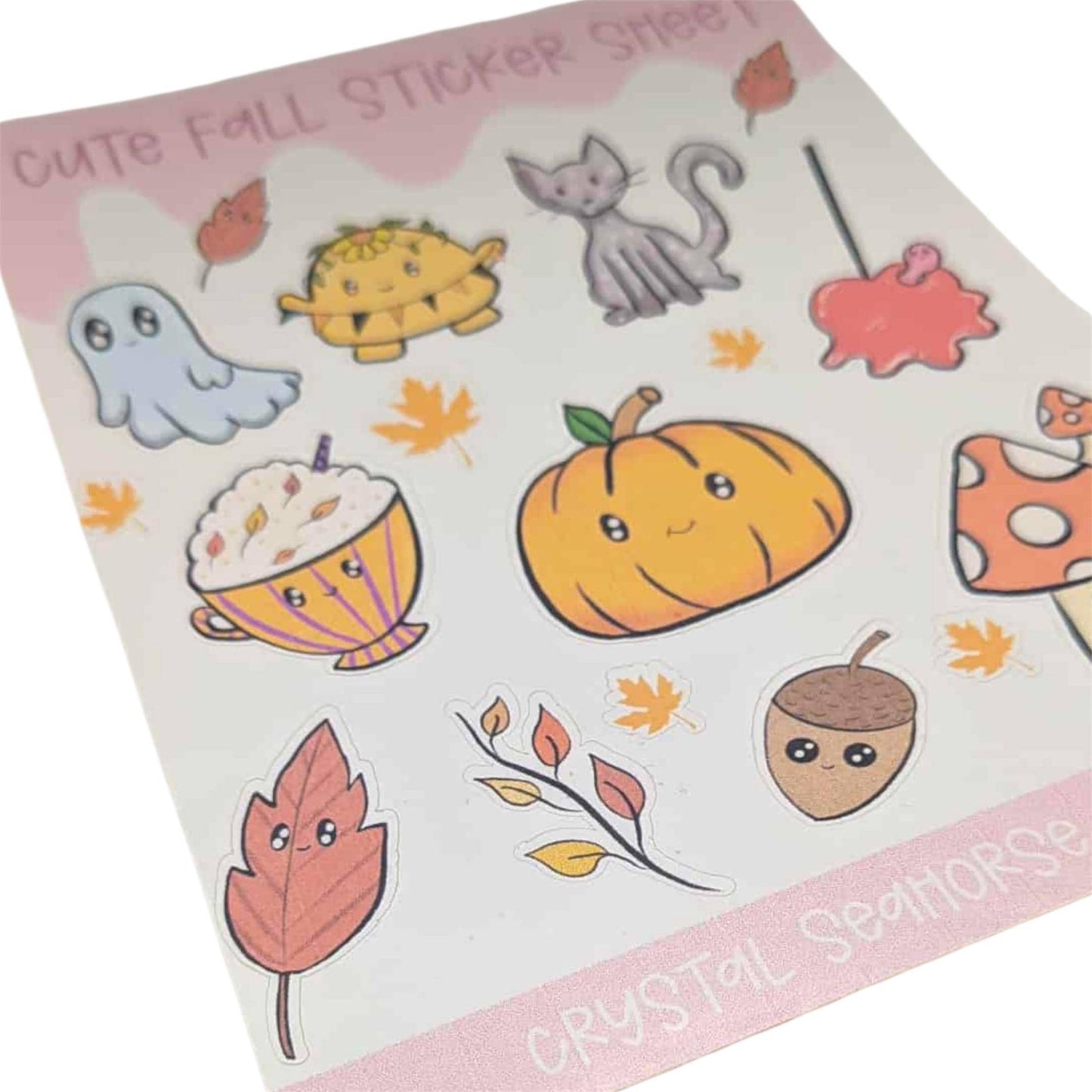 Sheet of cute fall-themed stickers with pumpkins, leaves, and other autumnal elements on a pink border.