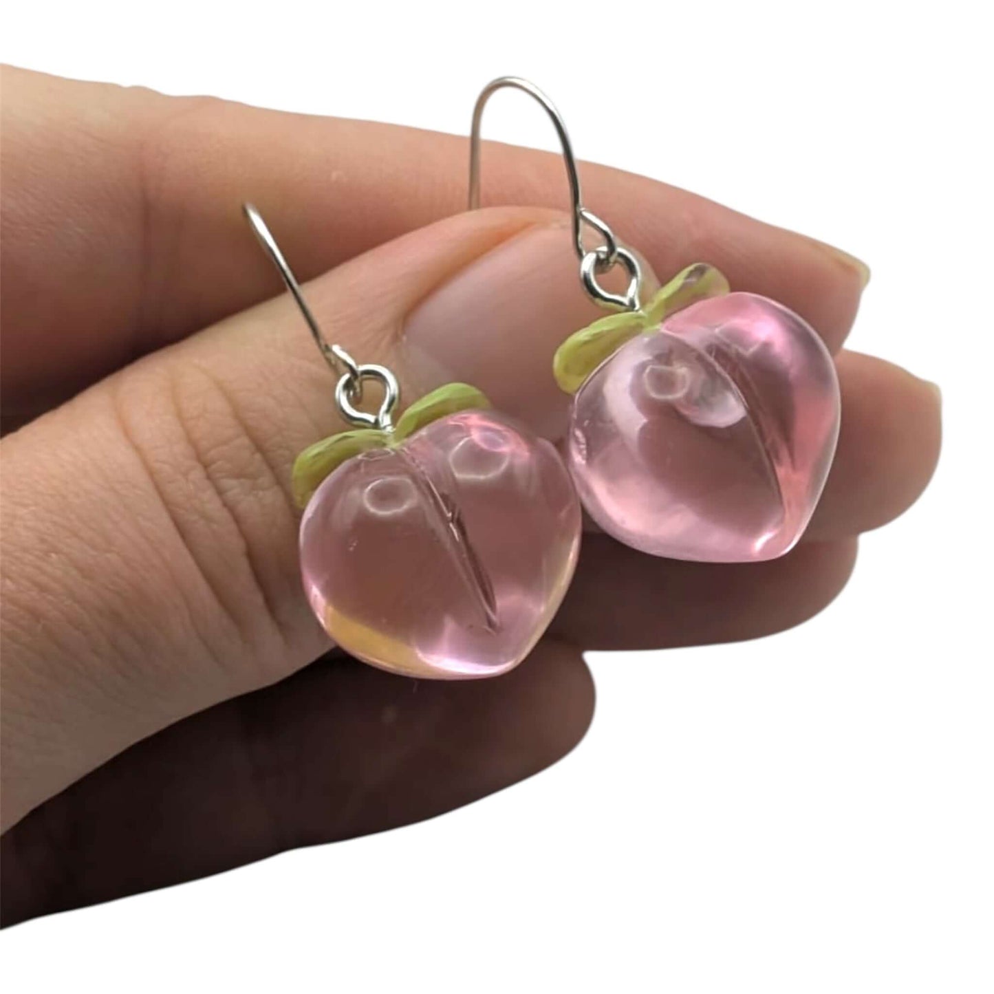 Cute kawaii peach earrings on a white background