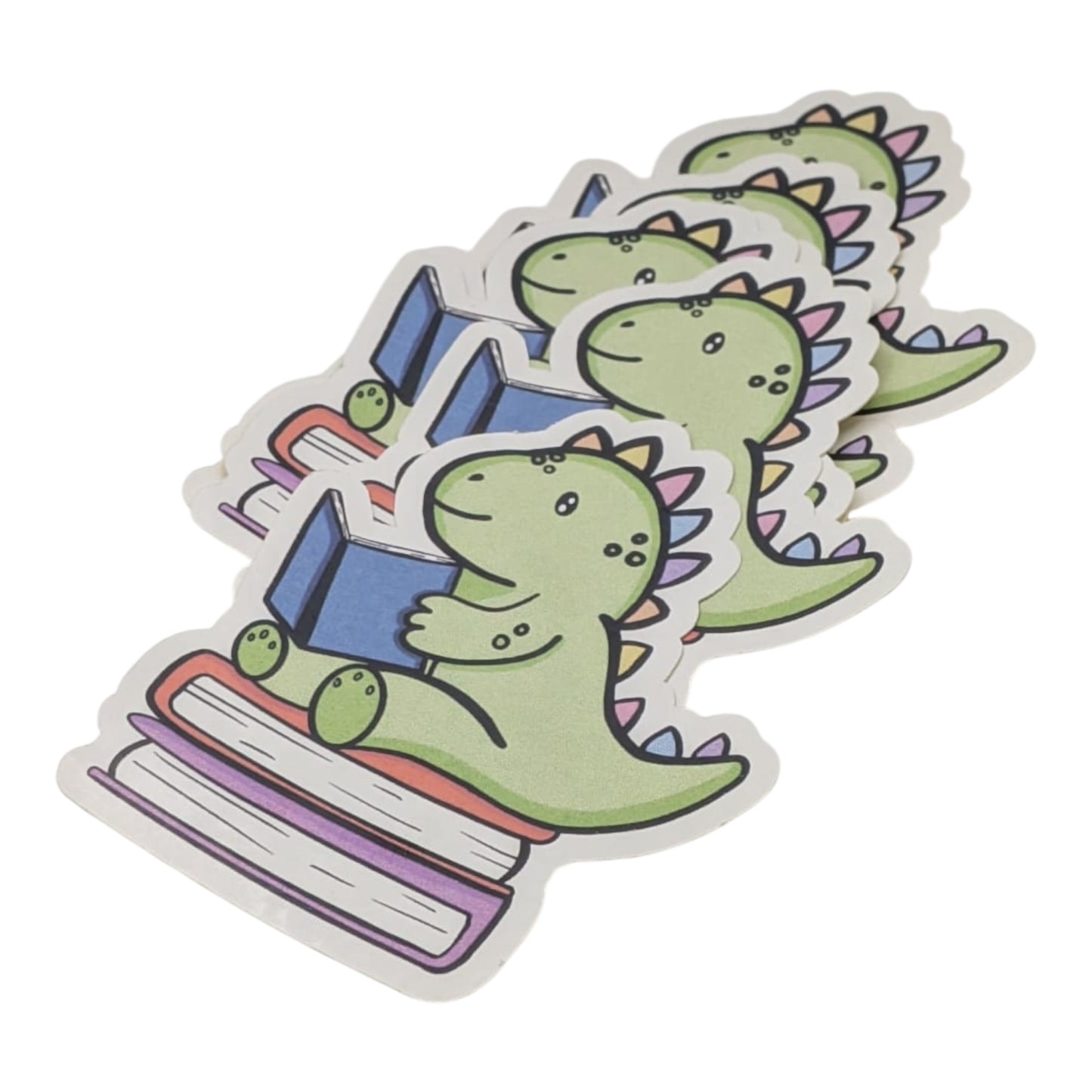 Stack of dinosaur stickers on white background