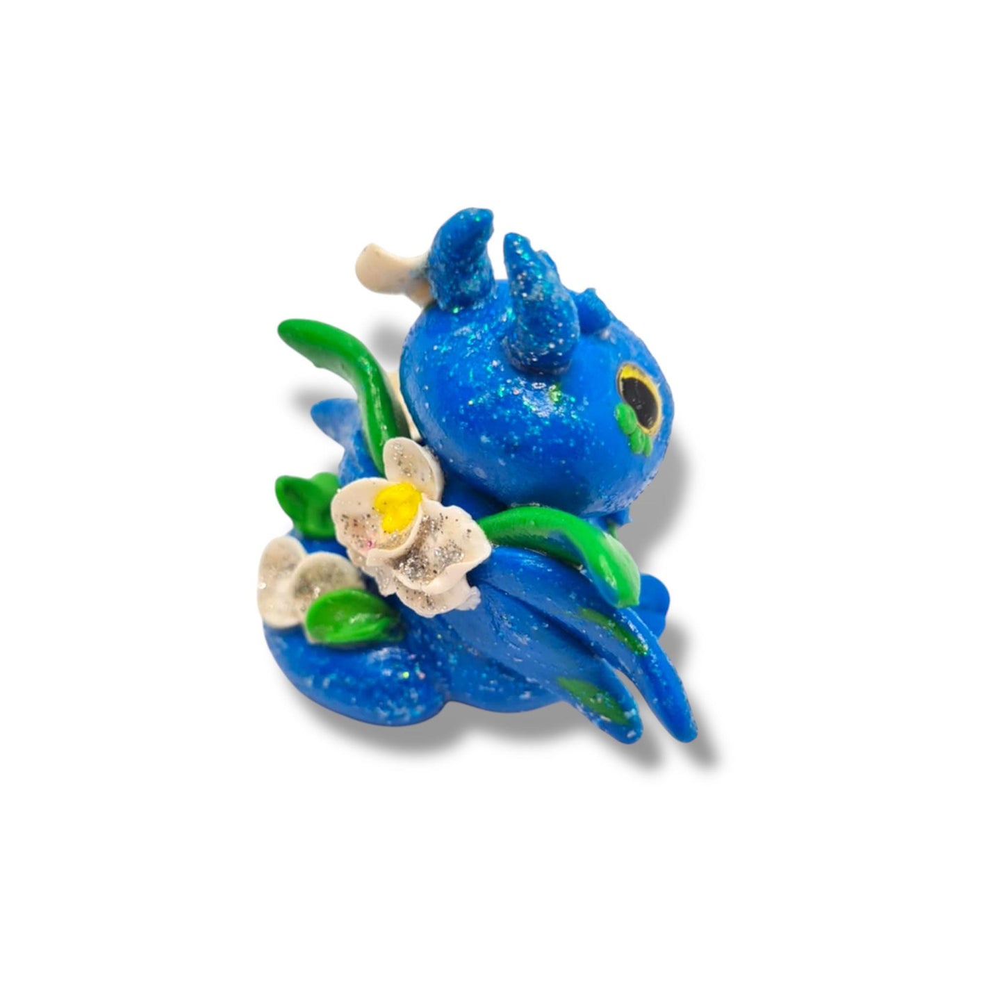 Blue figurine with floral elements on a white background
