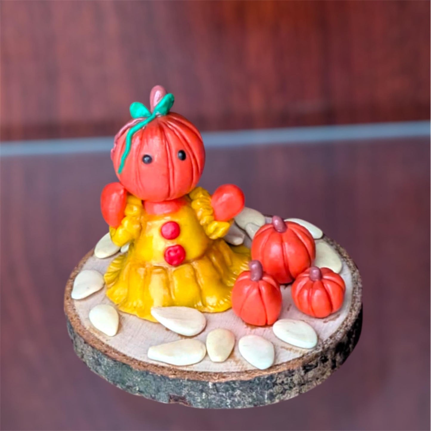 Pumpkin figure front view on a glass and wooden shelf