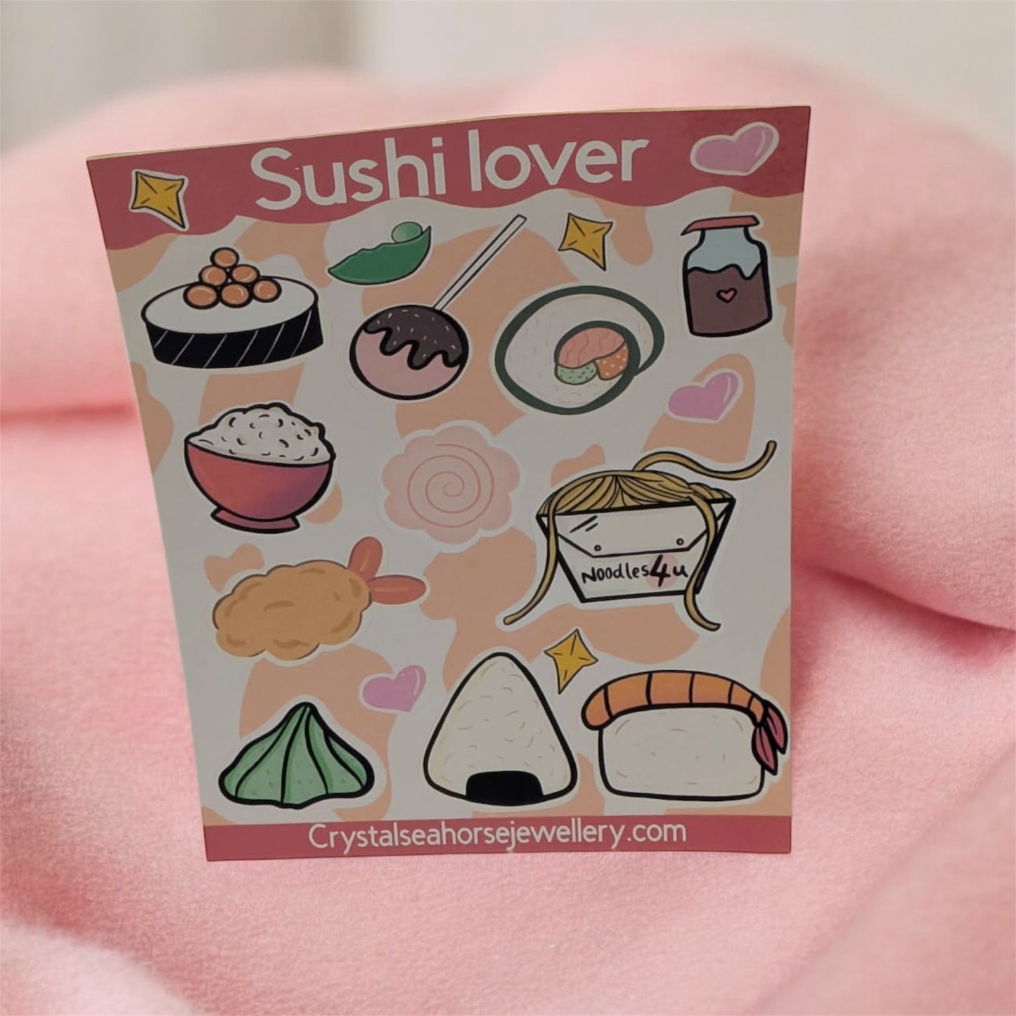 Sticker sheet with sushi-themed illustrations on a pink background