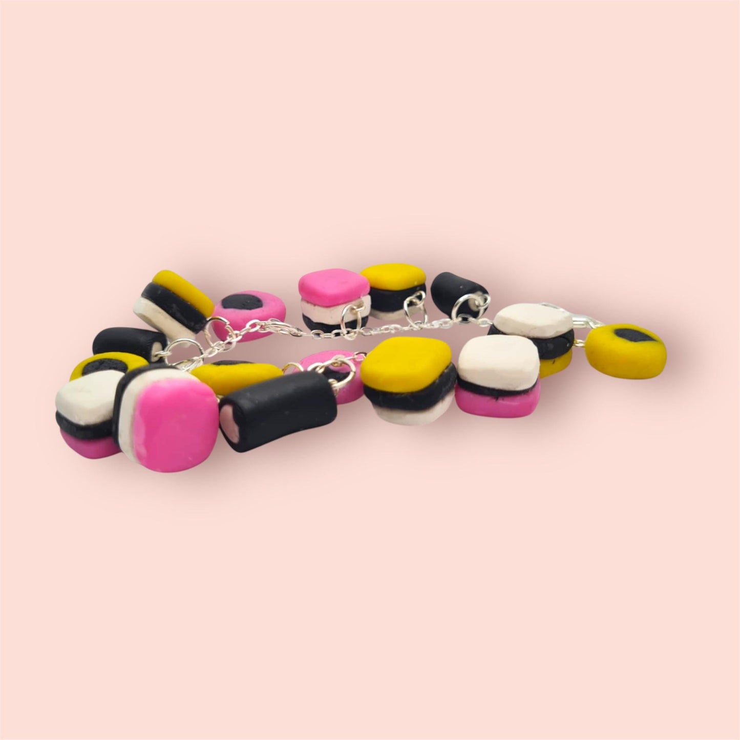 Colourful beaded bracelet on a pink background