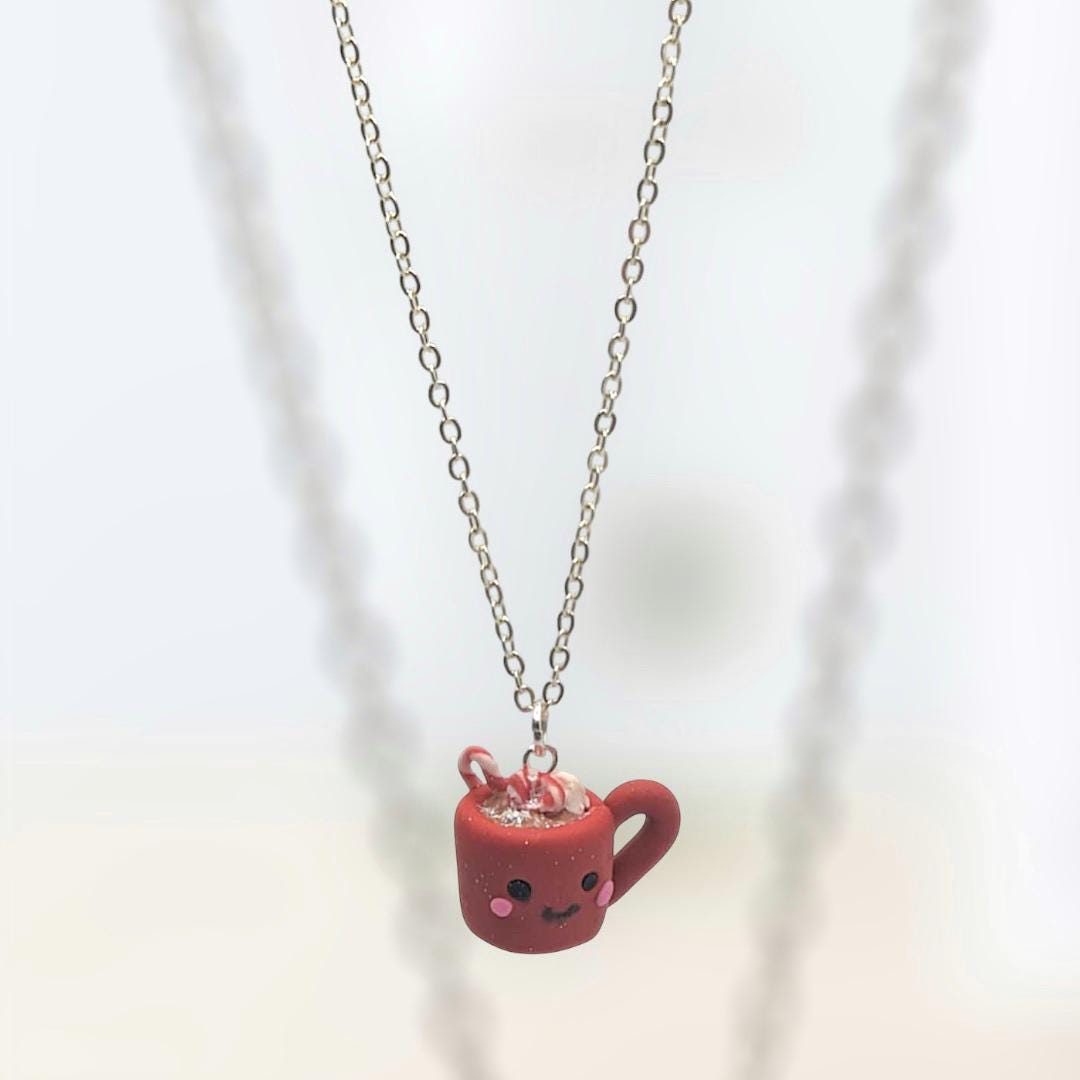 Necklace with festive pendant hanging from silver chain on white background 