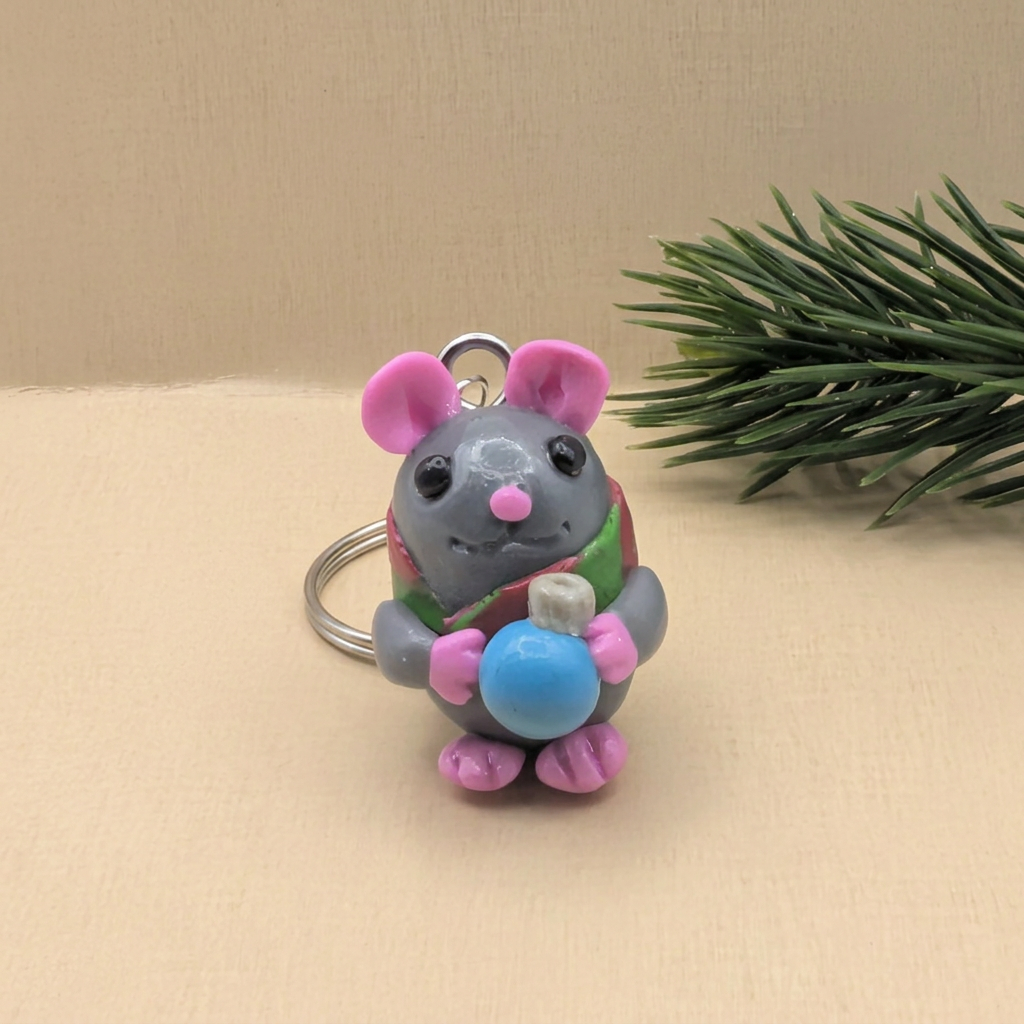 Christmas mouse keyring with pink ears, red-and-green scarf and blue bauble, front view