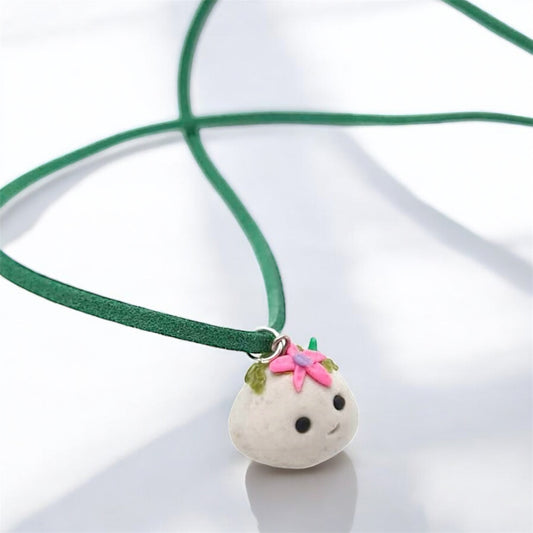 Mossy rock necklace with flower on white background 