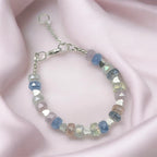 Beaded crystal bracelet with heart-shaped beads on a pink fabric background