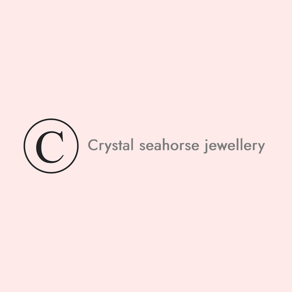 Crystal seahorse jewellery with a brand logo on a light pink background