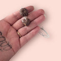 Handmade polymer clay chocolate box pendants on one necklace chain held in hand 