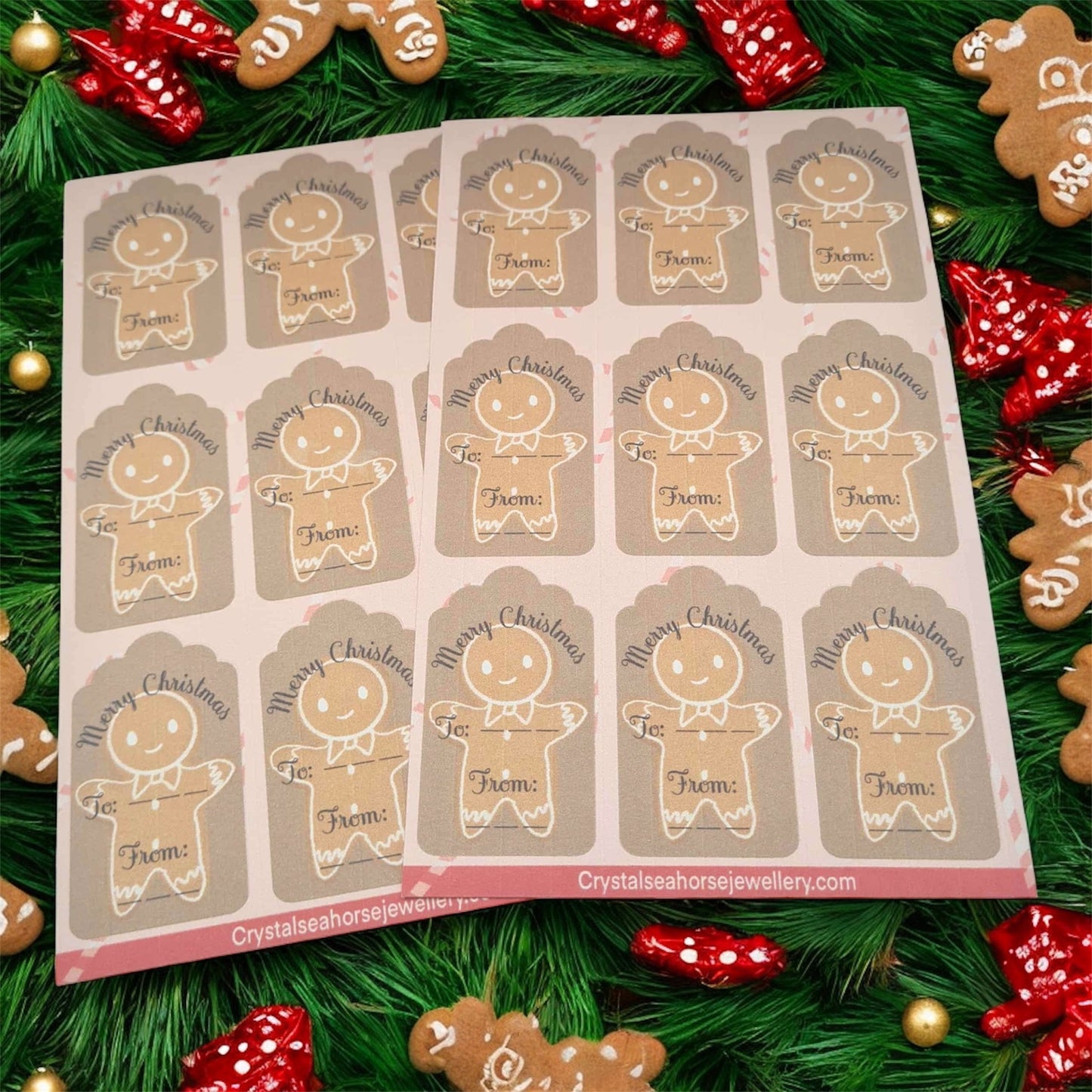 Sheet of gingerbread man-shaped stickers on a green leafy background with Christmas decorations.