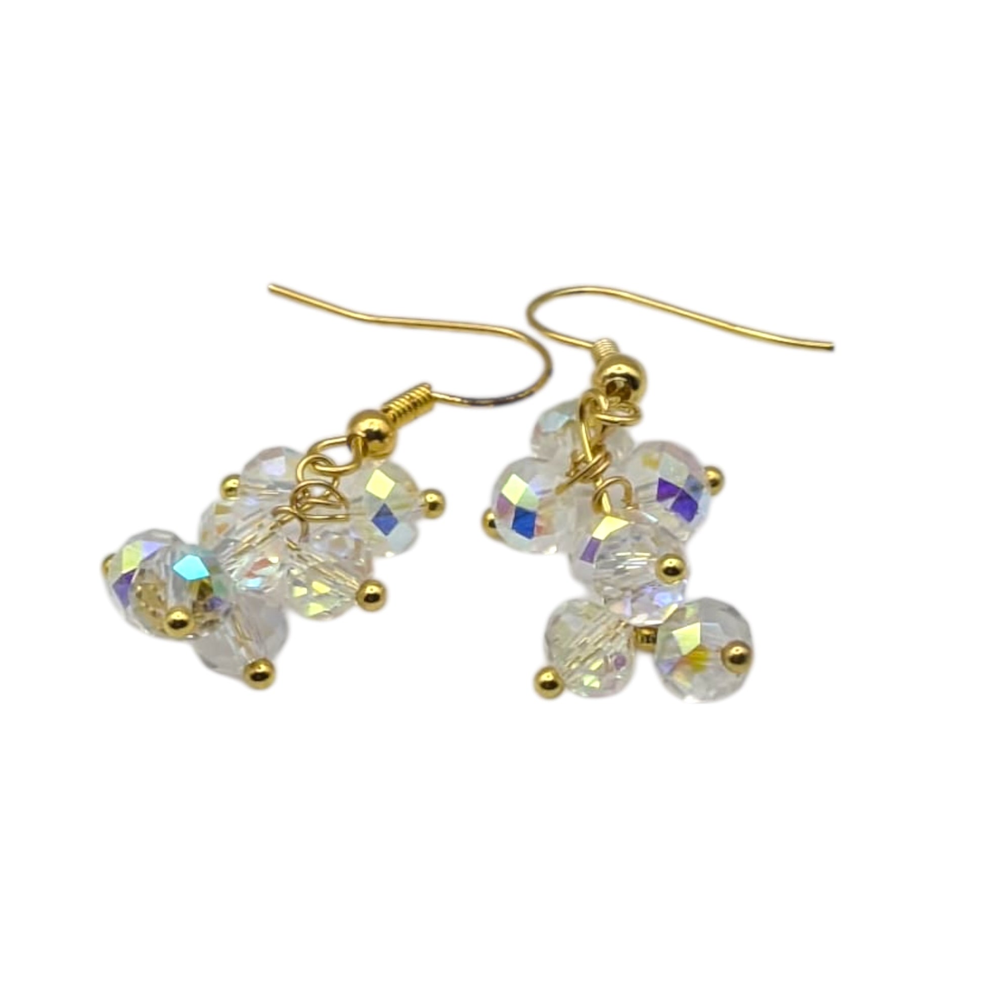 Gold crystal dangle earrings on white background 