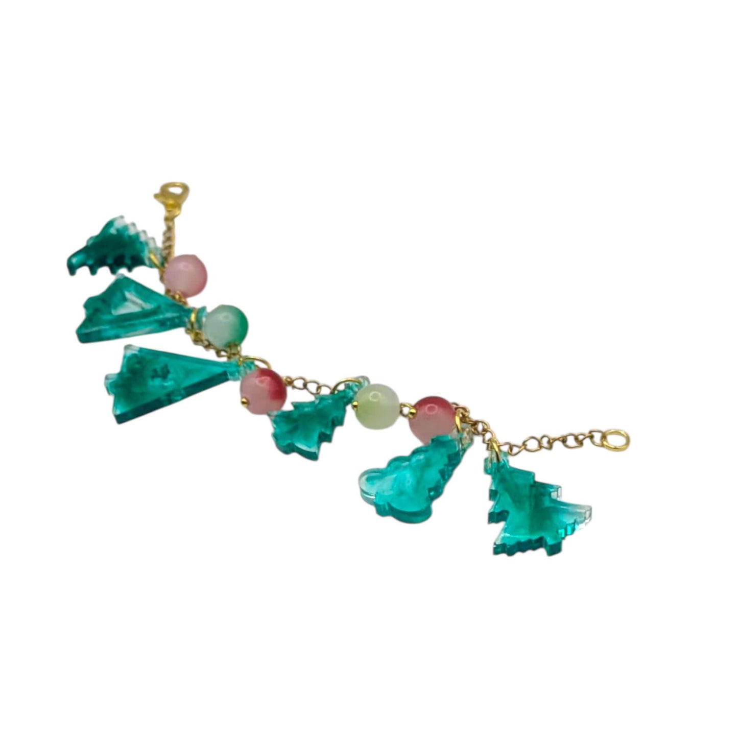 Festive bracelet with green pine tree -shaped pendants and pink beads on a white background