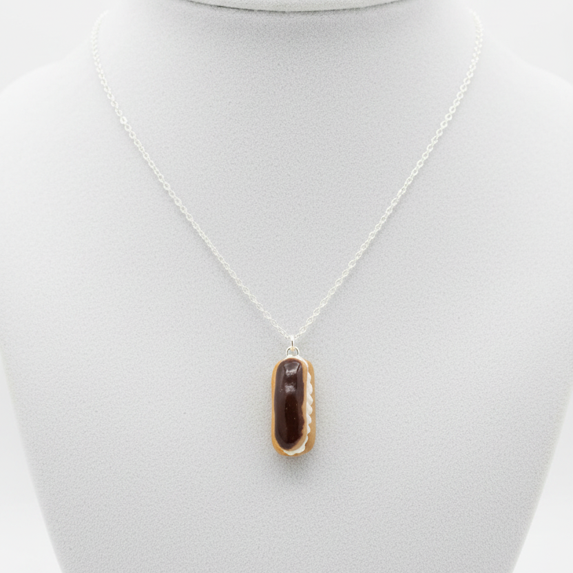 Chocolate eclair necklace side view on white background
