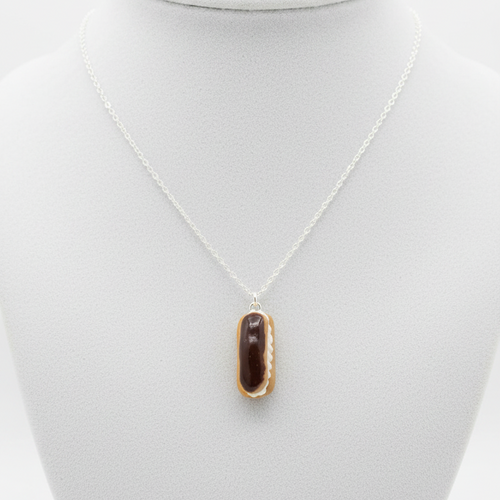 Chocolate eclair necklace side view on white background
