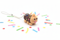 Caterpillar Cake Necklace with polymer clay pendant on white background with confetti