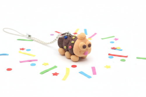 Caterpillar Cake Necklace with polymer clay pendant on white background with confetti
