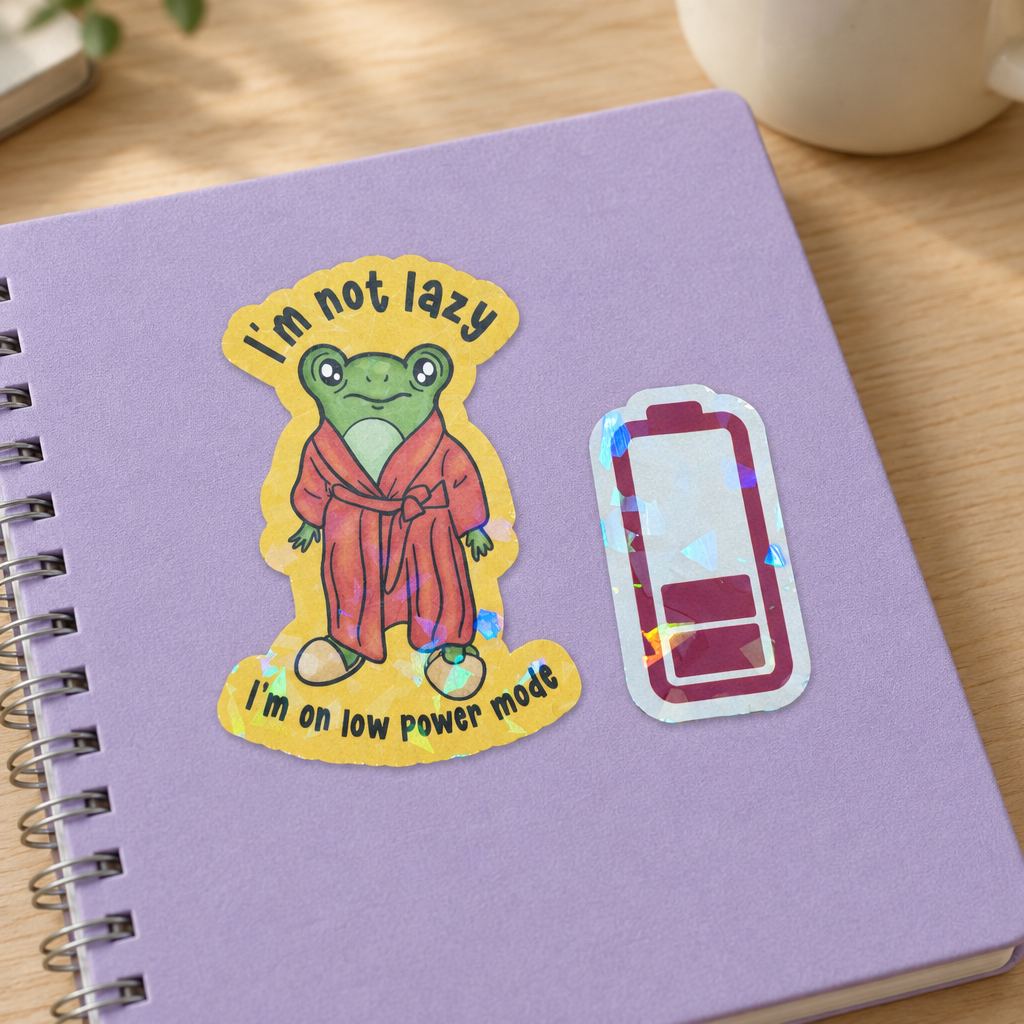 Frog and battery low power mode sticker on notebook
