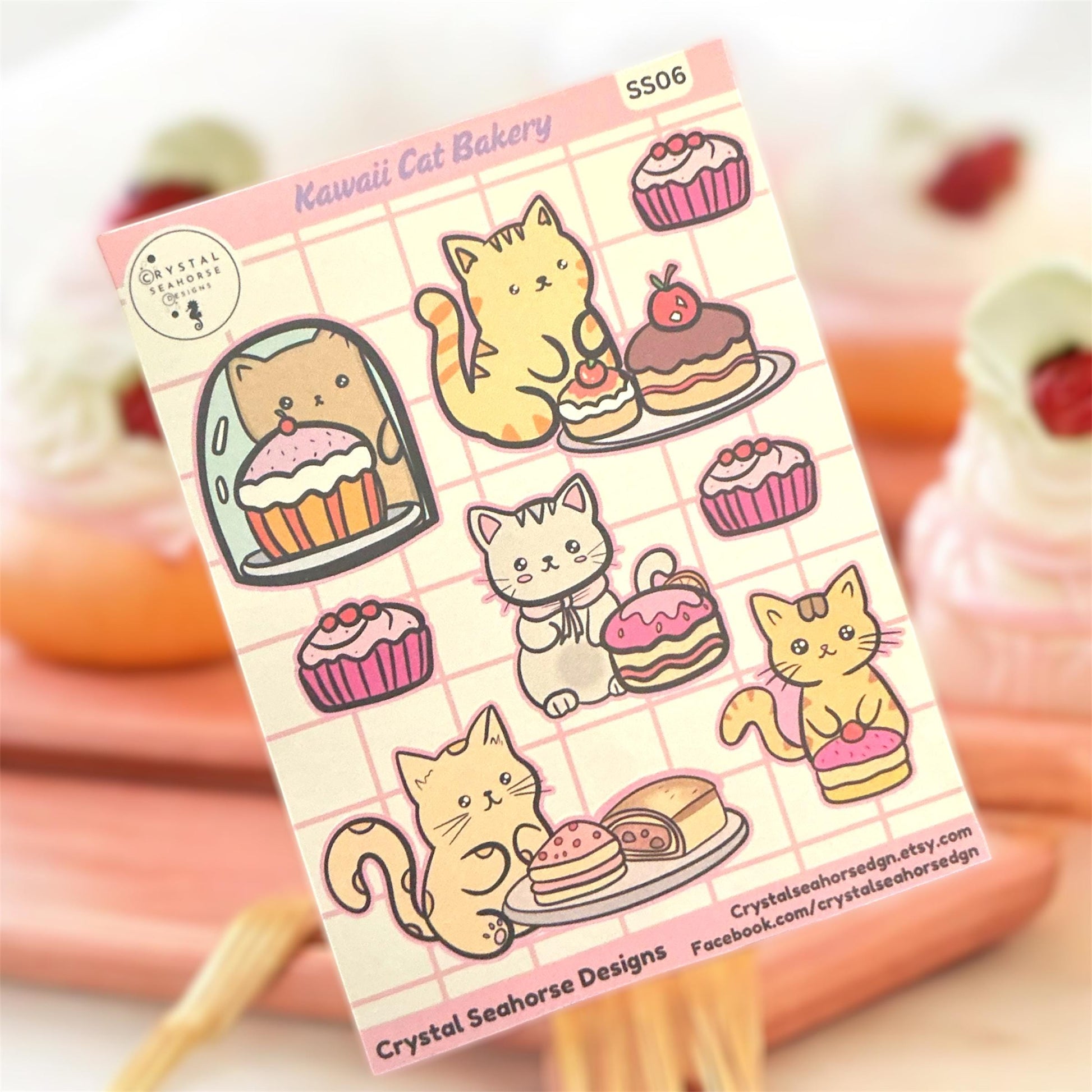 Sticker sheet with cute cat and cake designs on a pink grid background