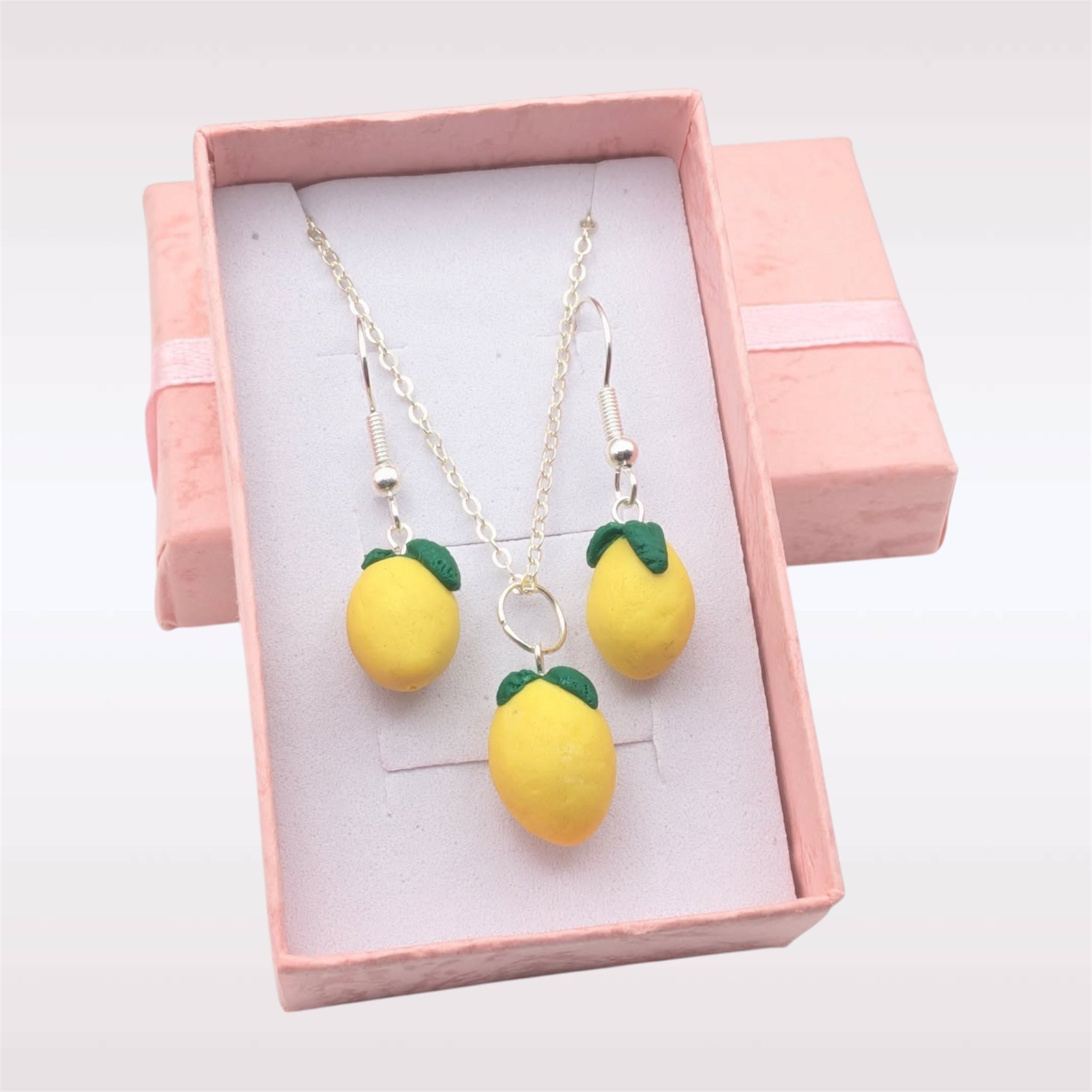 Polymer clay lemon jewellery set featuring earrings and necklace in a light pink gift box