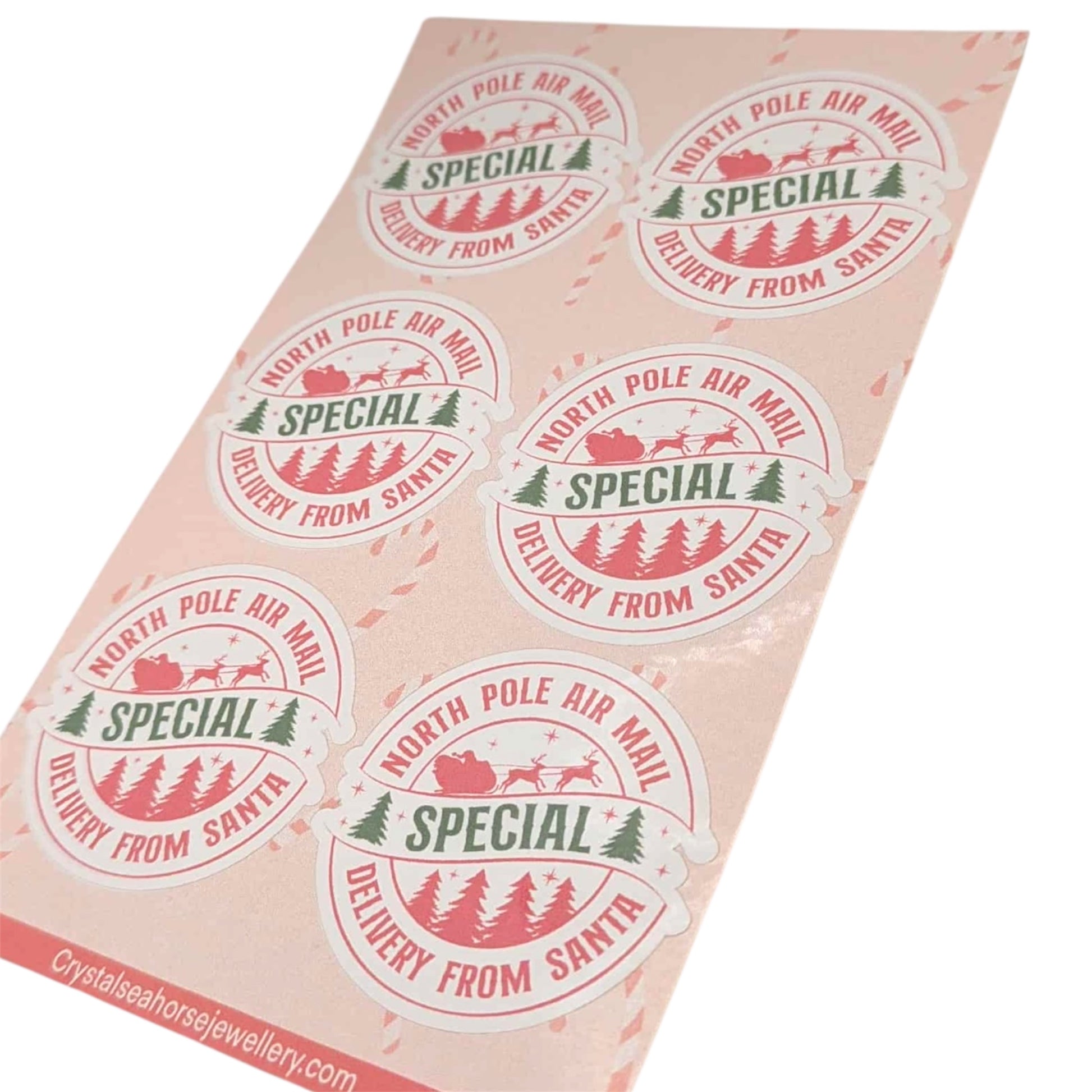 Glossy sticker paper with festive design and text 'Special Delivery from Santa' on a light pink background.