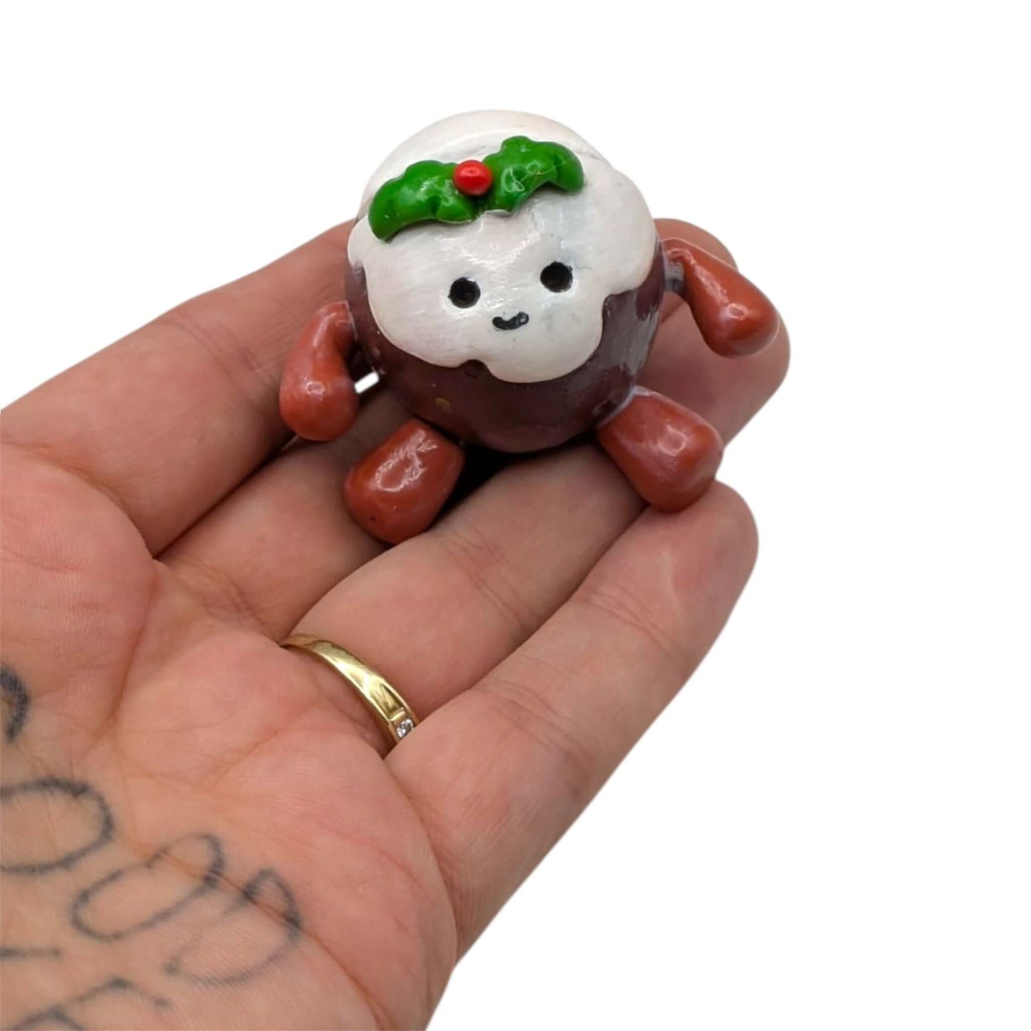 Polymer clay Christmas figurine held in hand 