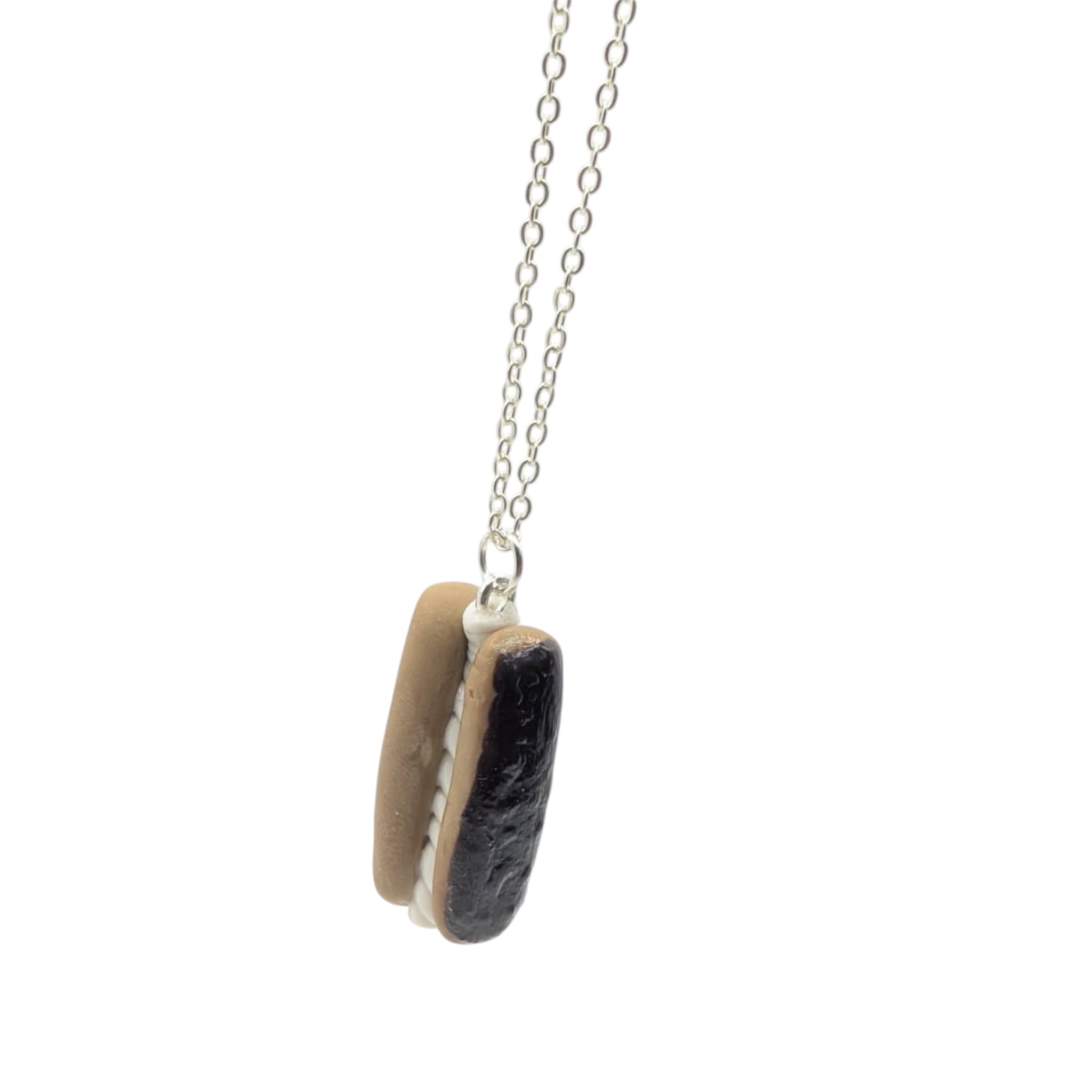 Chocolate eclair necklace on jewellery display bust