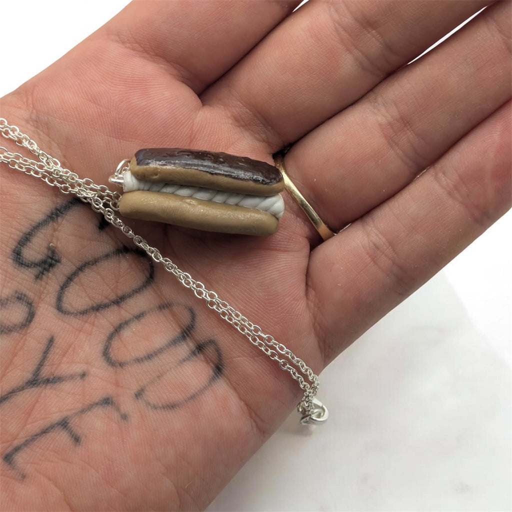 Chocolate eclair necklace on concrete prop