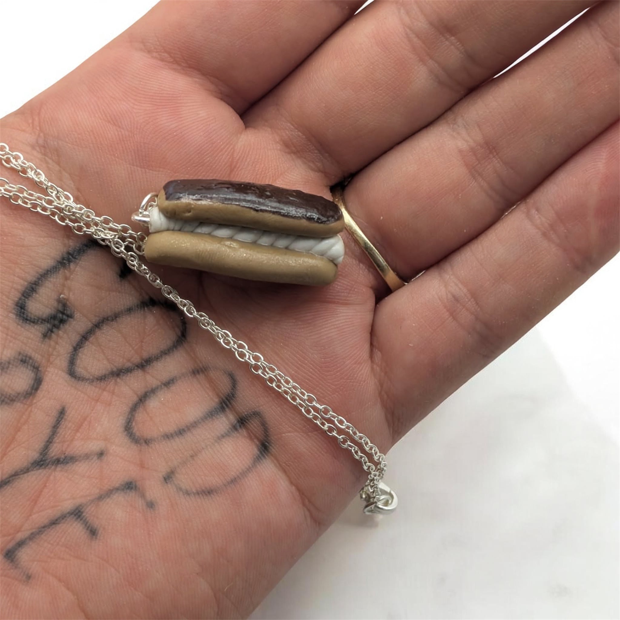 Chocolate eclair necklace on concrete prop