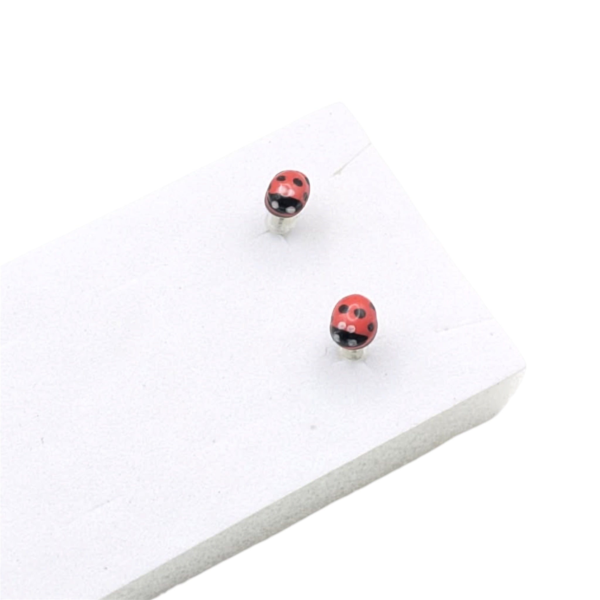 Ladybird stud earrings on white display block