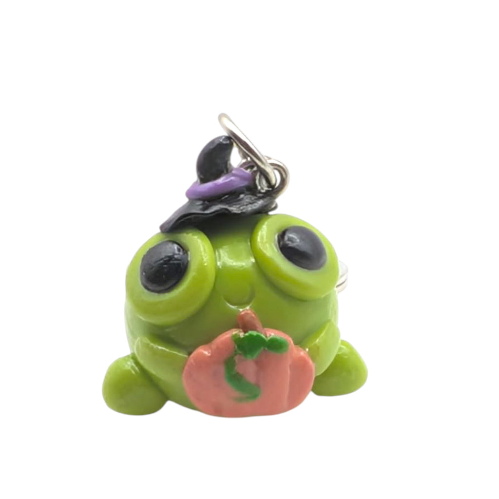 Close-up of handmade kawaii Halloween frog keyring charm with witch hat and miniature pumpkin detail