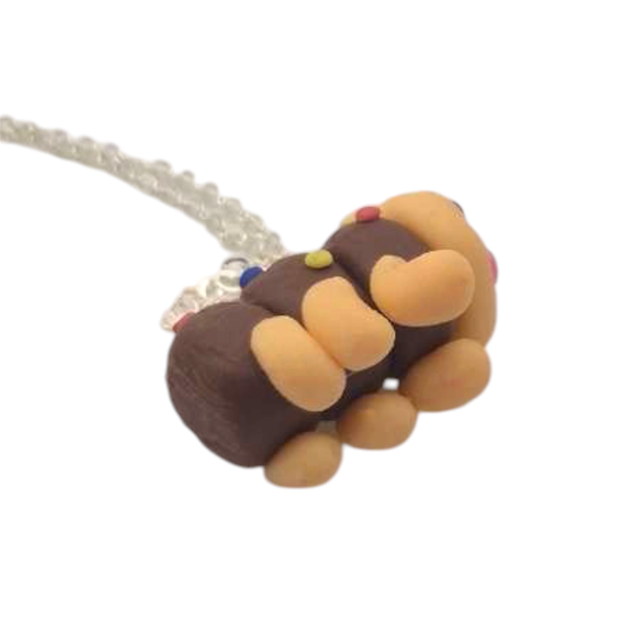 Caterpillar Cake Necklace pendant showing gloss finish and sculpted texture