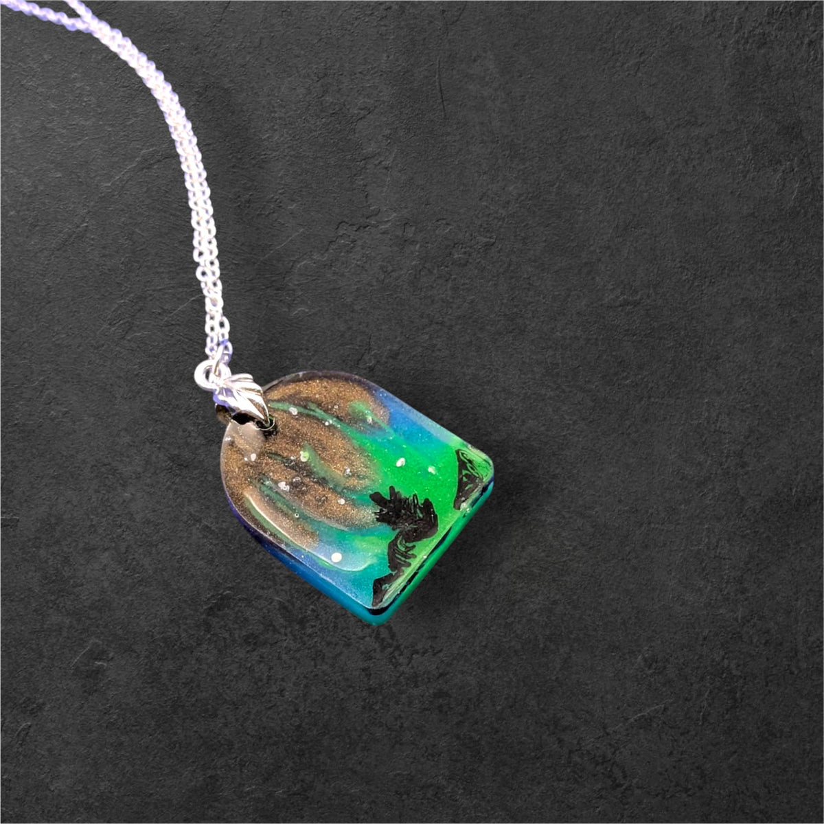 Aurora Borealis Necklace glowing green in the dark