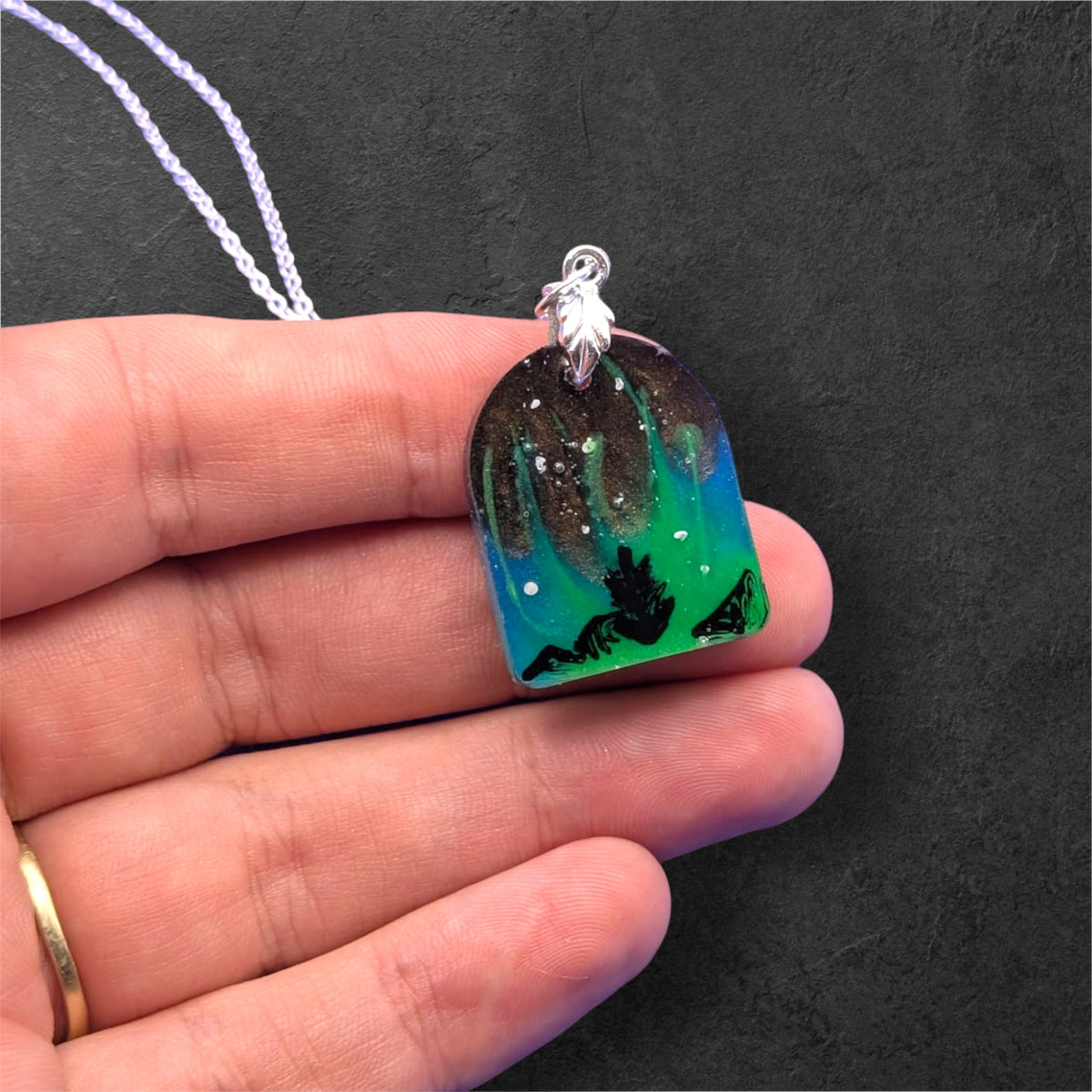 Aurora Borealis Necklace held in hand to show size
