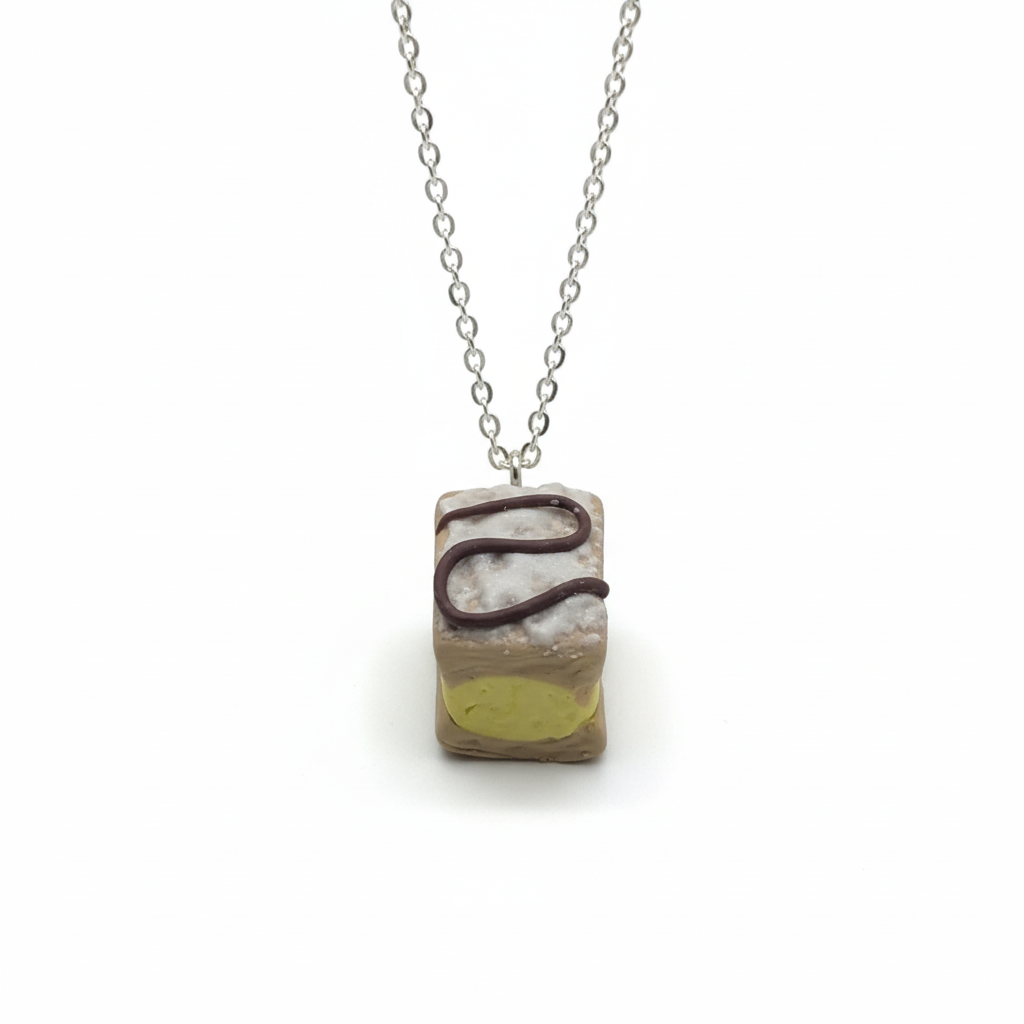 Handmade cake pendant necklace polymer clay jewellery on white background 