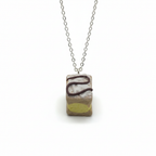 Handmade cake pendant necklace polymer clay jewellery on white background 