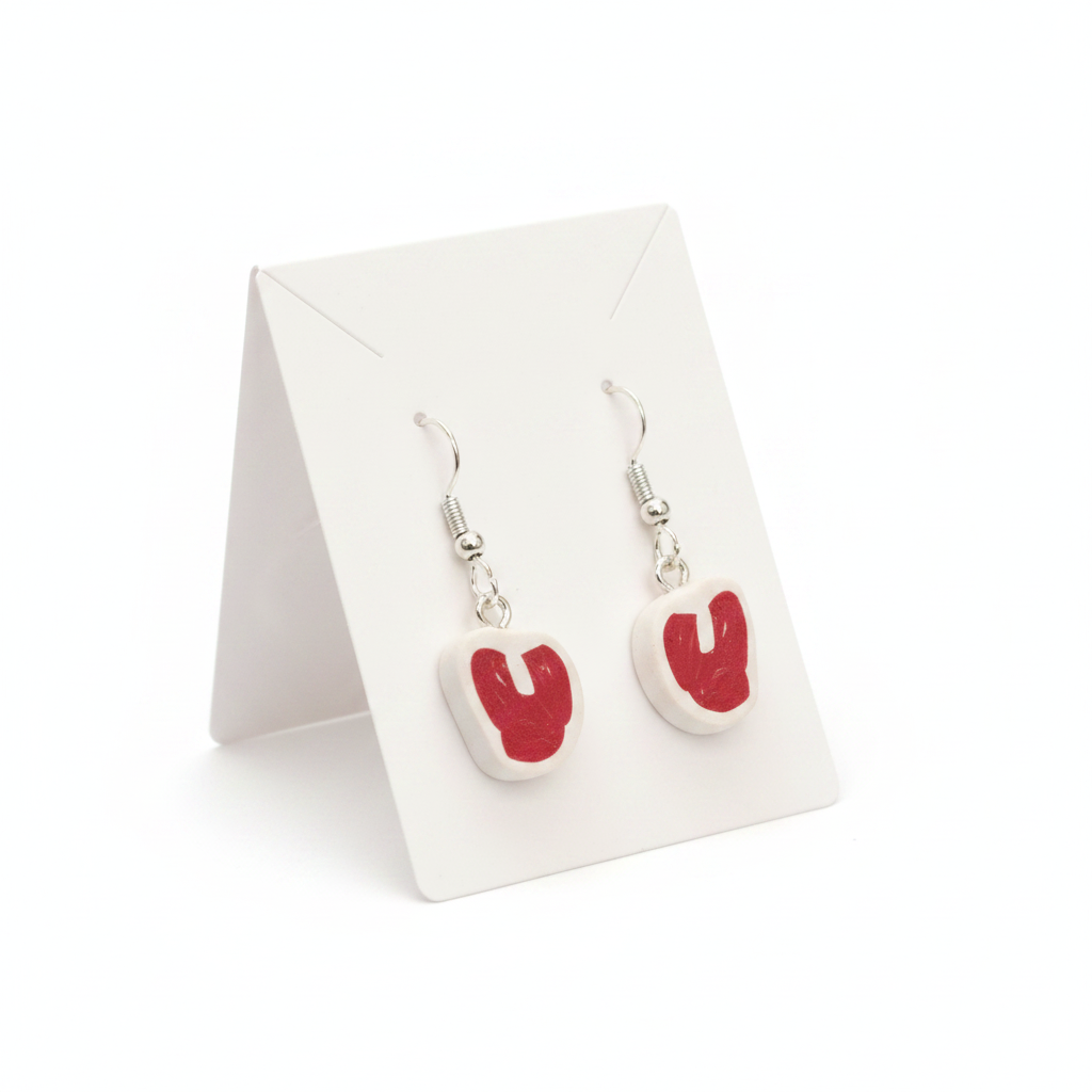 Red and white raw steak earrings  polymer clay drop earring worn on an ear