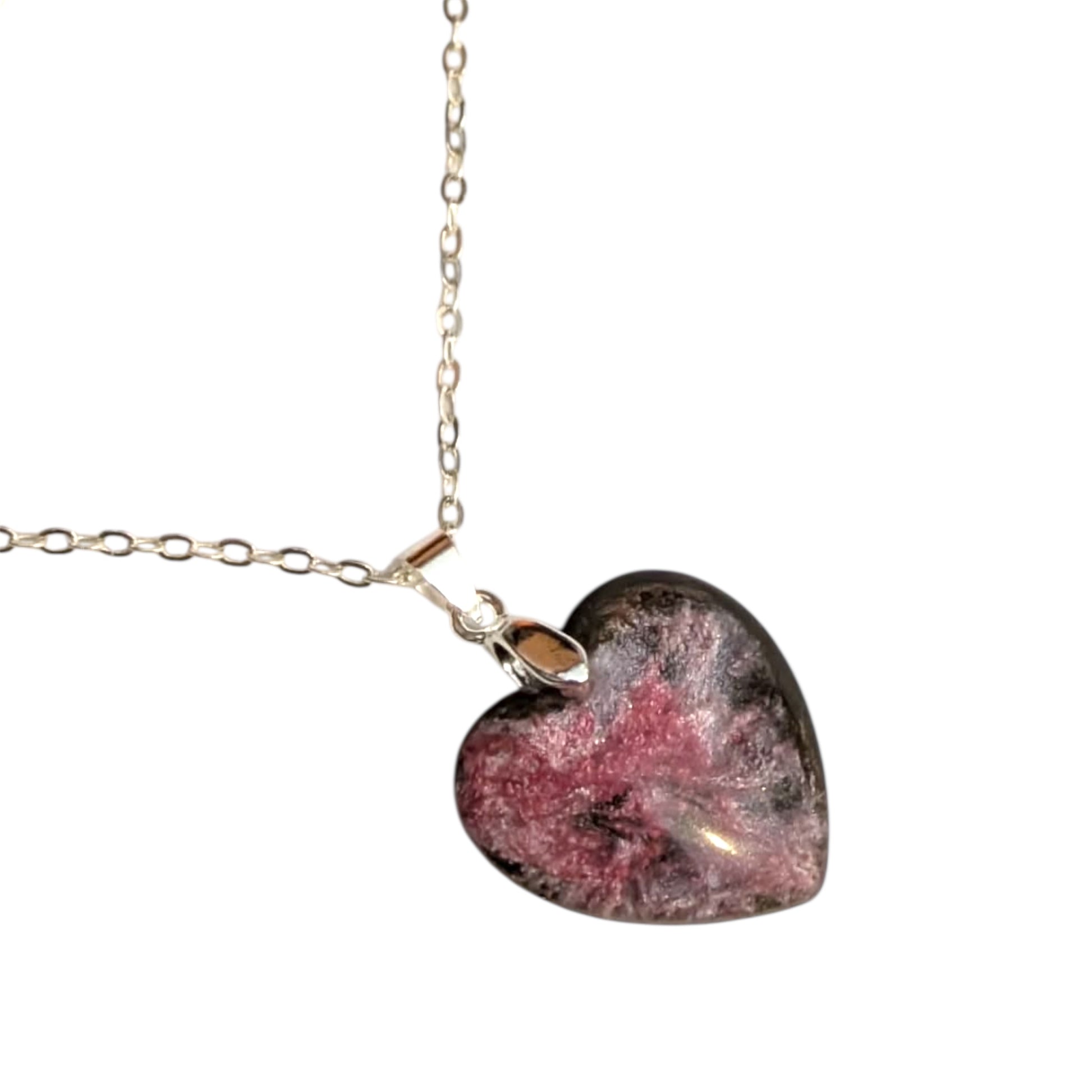 Heart-shaped pink resin pendant on a silver chain against a white background