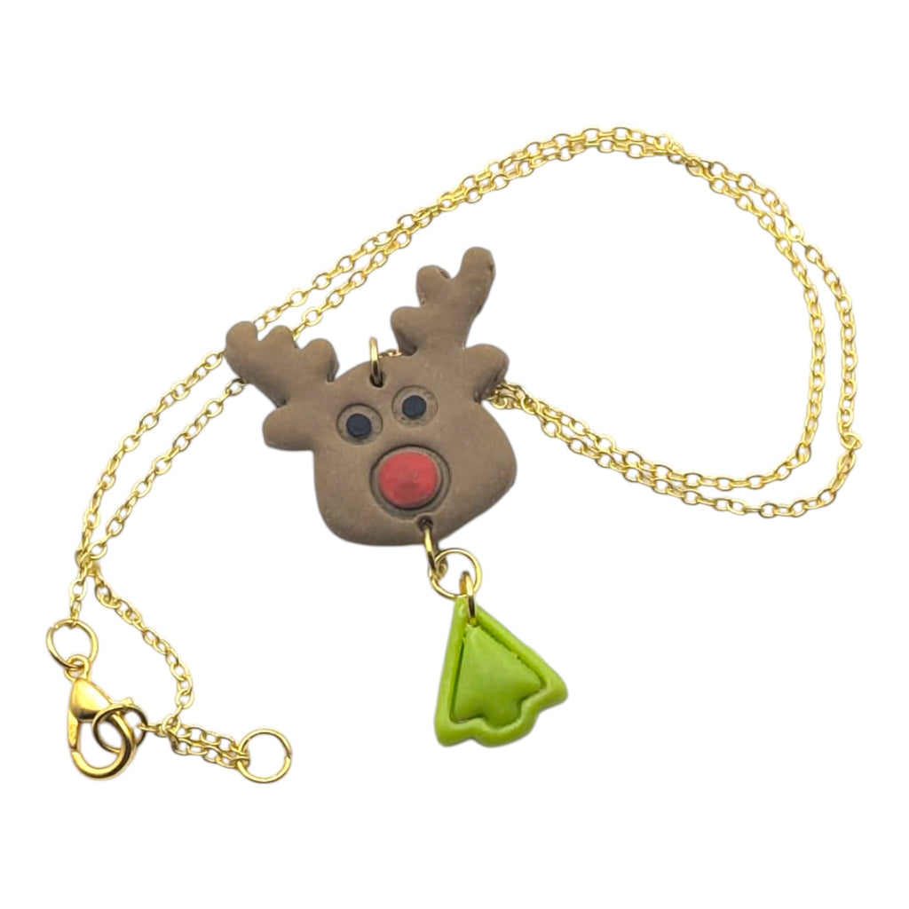 Necklace with a reindeer pendant and green leaf charm on a white background