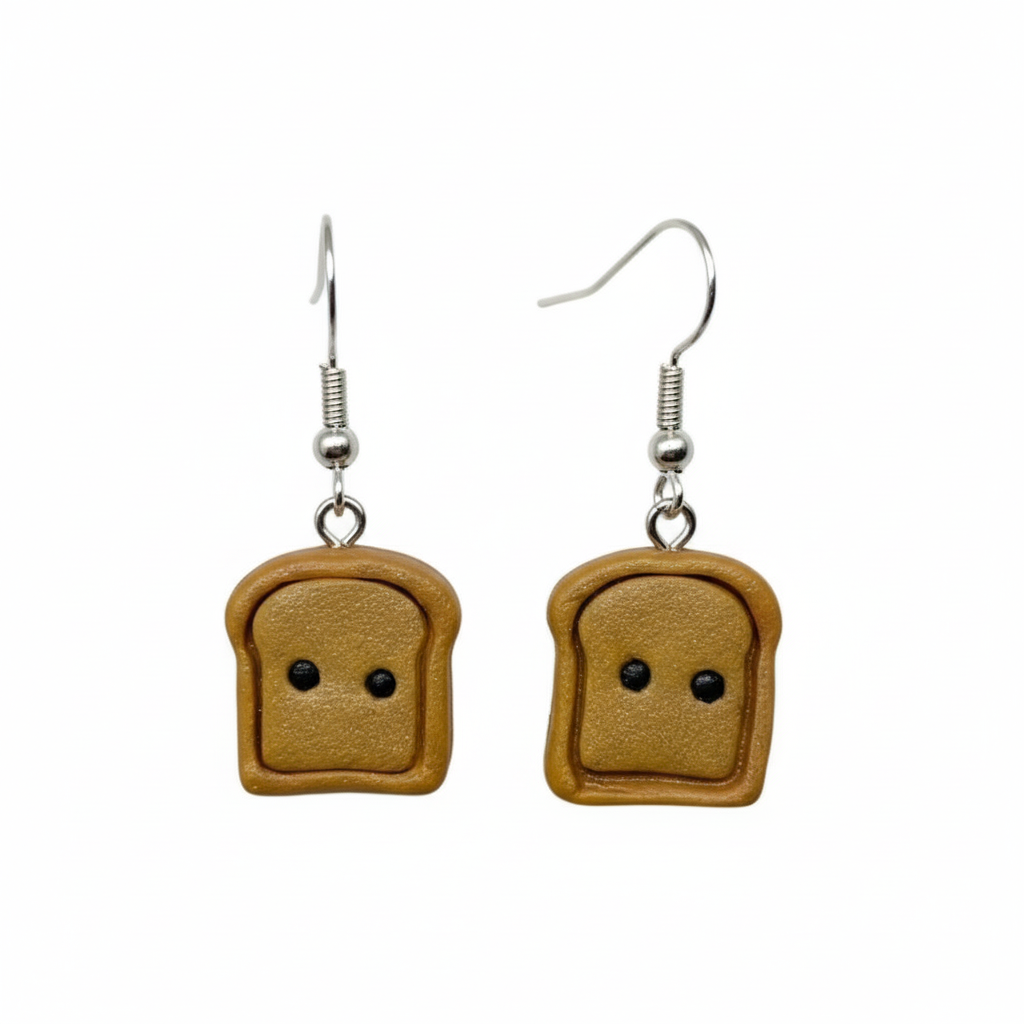 Toast earrings with black eyes cute kawaii jewellery on white background. 