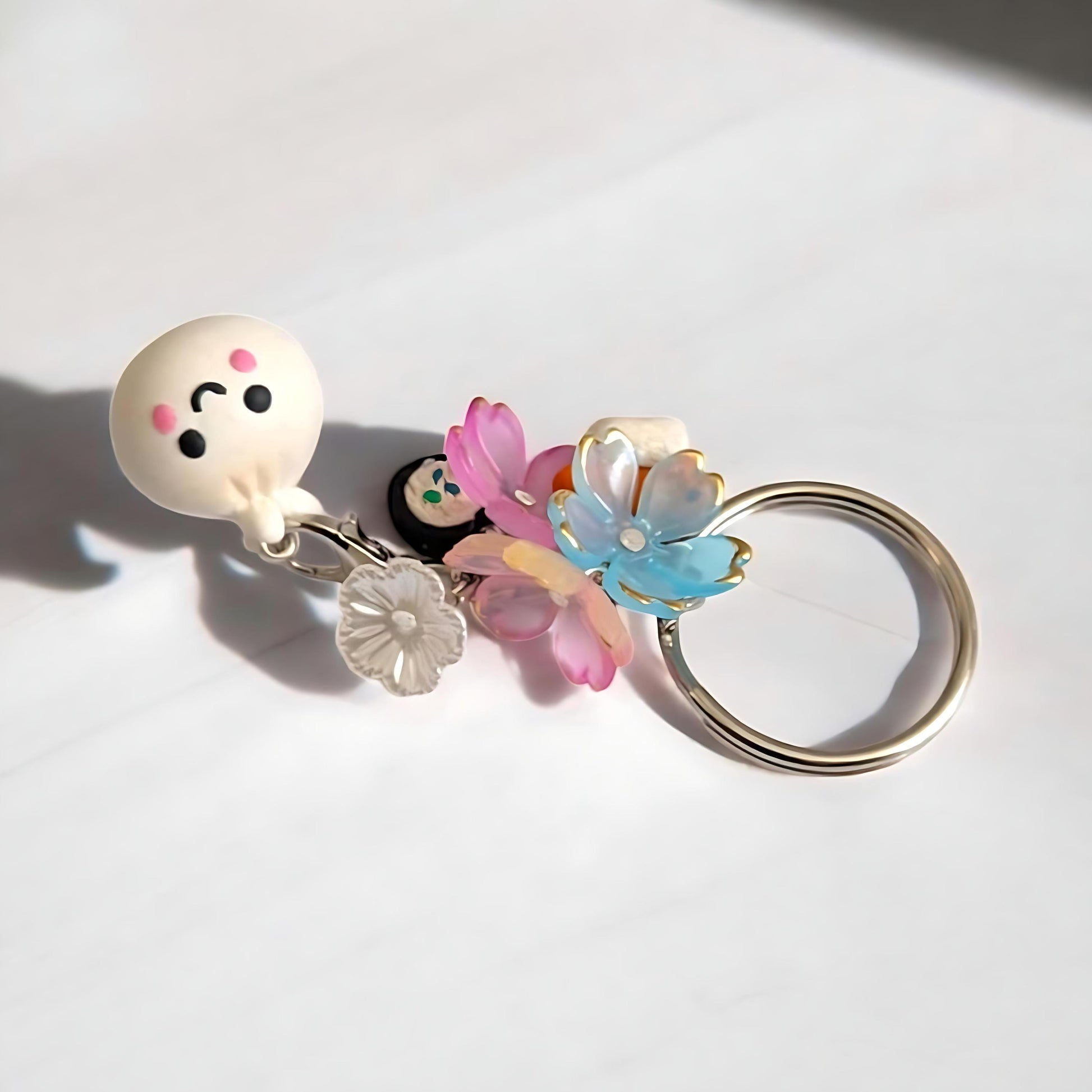 Keychain with a cartoon character and colorful flowers on a white background