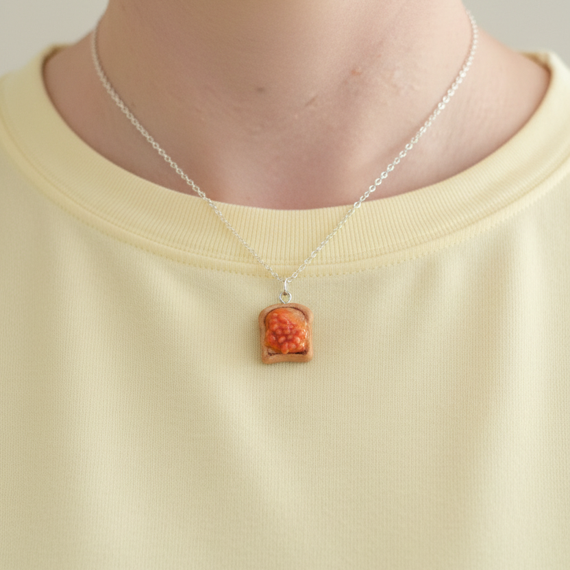 Beans on Toast Necklace worn around neck of Someone wearing a yellow shirt 