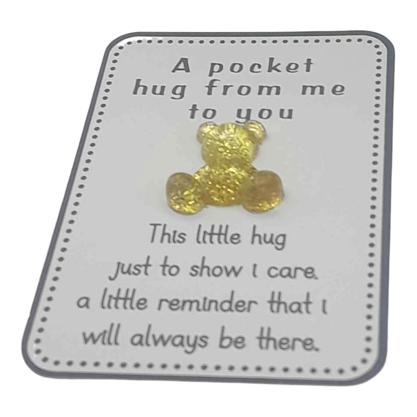 Gold teddy bear on a card with text 'A pocket hug from me to you' and 'This little hug just to show I care'.