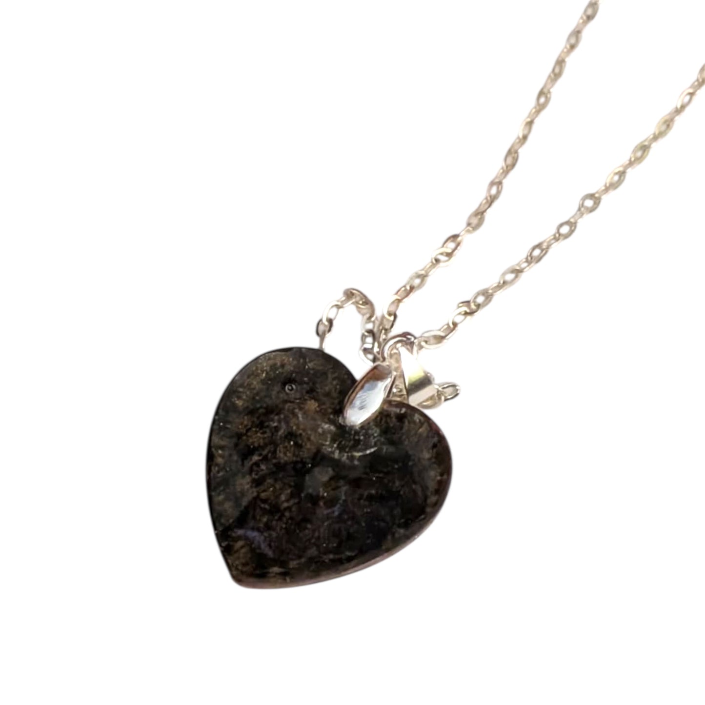 Back of necklace with a heart-shaped dark backing pendant on a white background