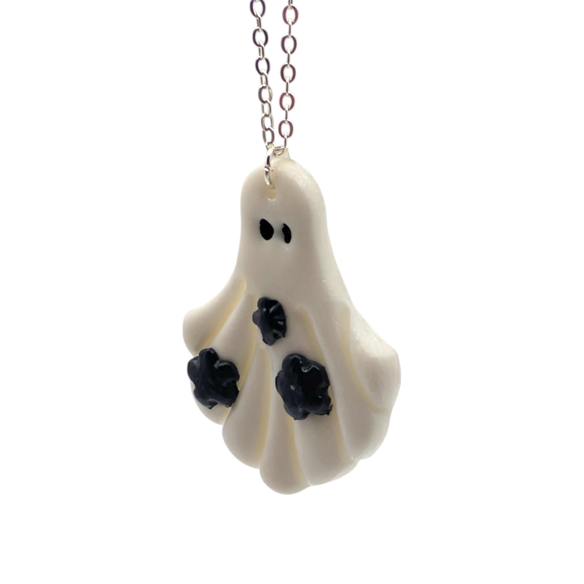 Ghost-shaped pendant with black accents on a white background