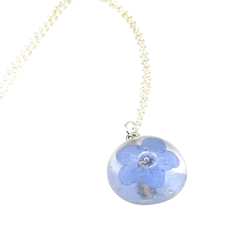 Necklace with a blue flower pendant on a white background