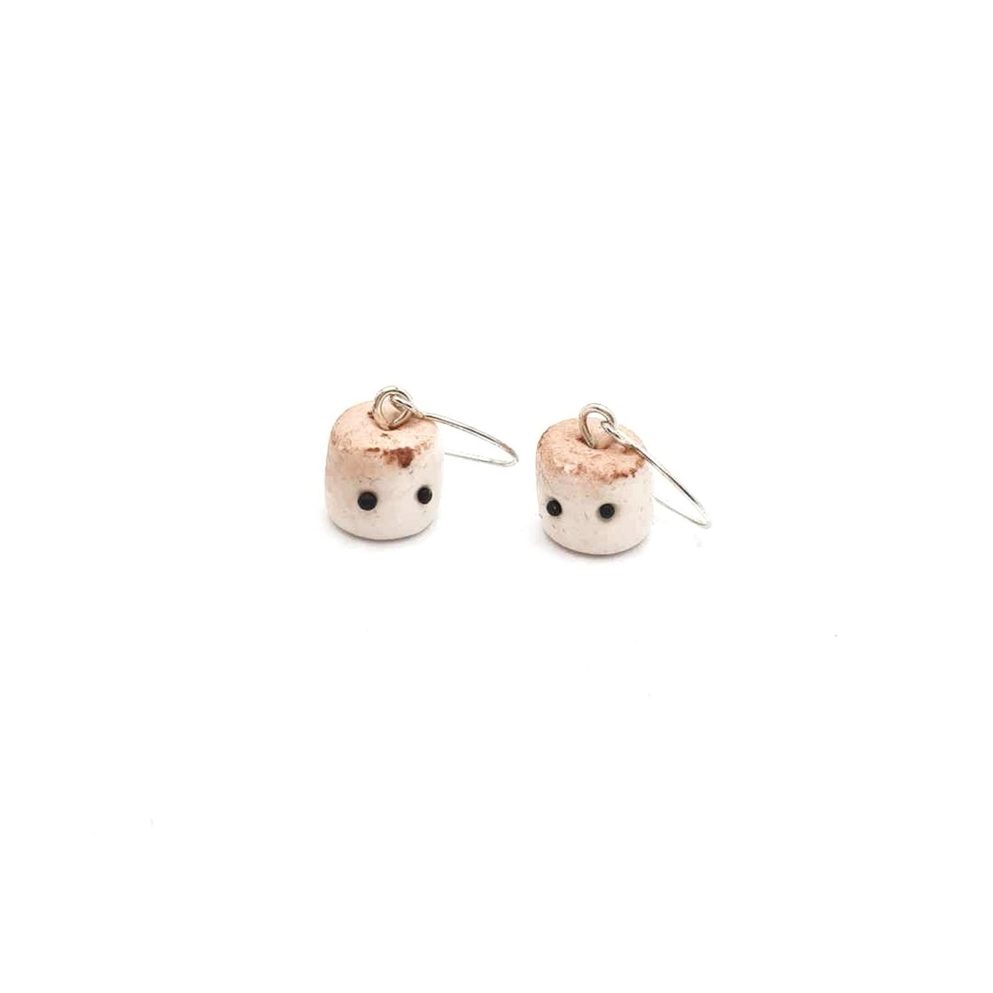 Pair of small earrings with a white background