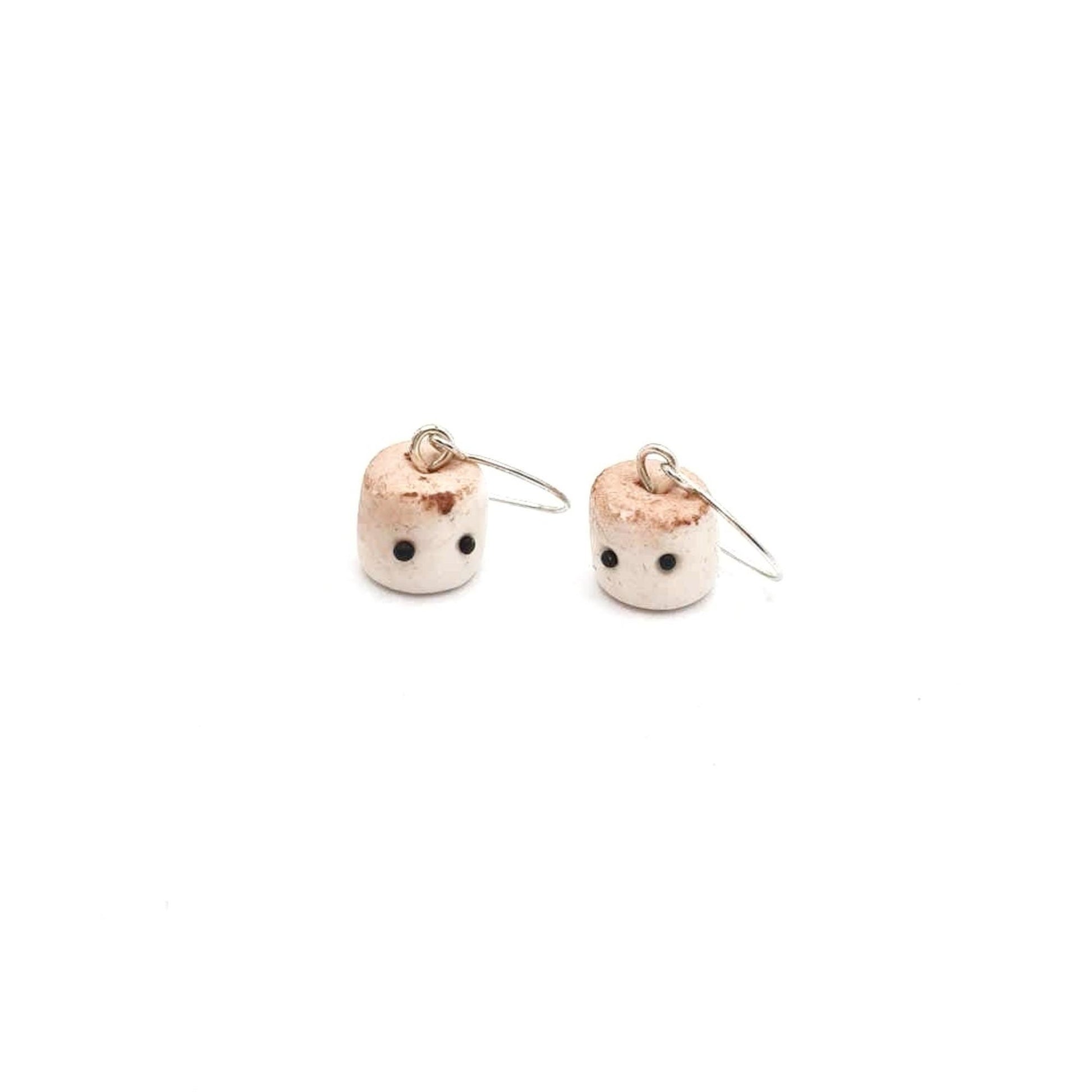 Pair of small earrings with a white background