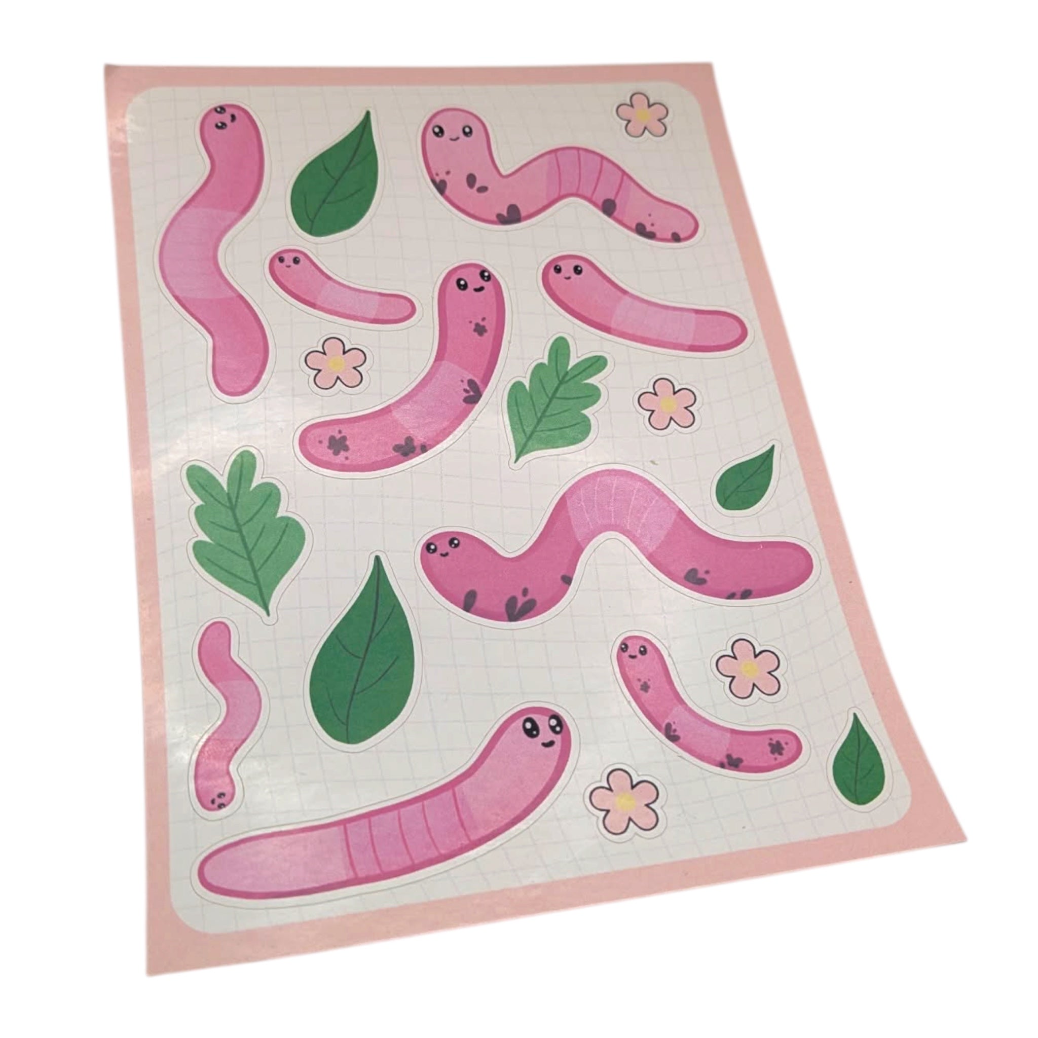 Sheet of pink worm stickers with green leaves and flowers on a white background