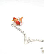 Silver chain with a rooster-shaped charm on a white background
